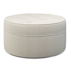 a white round ottoman sitting on top of a floor