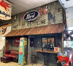 the inside of a building with old signs and antique items on it's walls