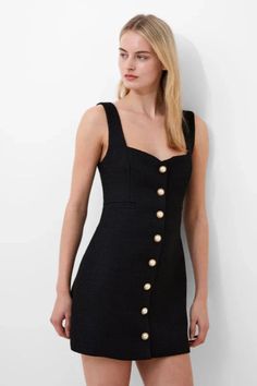 Woman in a black mini dress with pearl buttons, looking to the side. Tweed Fashion, Structured Dress, Button Front Dress, Tweed Dress, Sweetheart Neck, Strap Dress, French Connection, Front Design, Welt Pockets