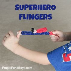 a young boy holding a toothbrush with the words superhero fingers written on it in red, white and blue