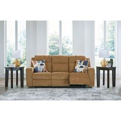 a living room scene with focus on the reclining sofa and two end tables in the background