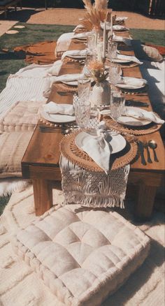 a long table set with place settings for dinner