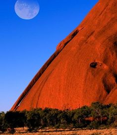 the moon is setting over aye rock in australia