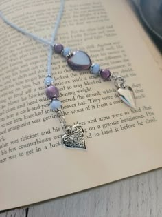 a book with a necklace on top of it