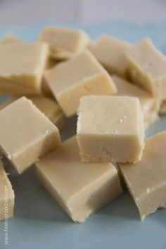 several pieces of cheese sitting on top of a wooden cutting board