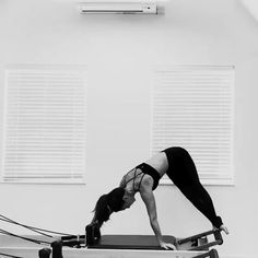 a woman is doing exercises on a rowing machine