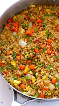 a pot filled with rice and vegetables on top of a stove