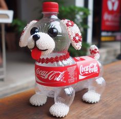 a plastic coca - cola bottle shaped like a dog