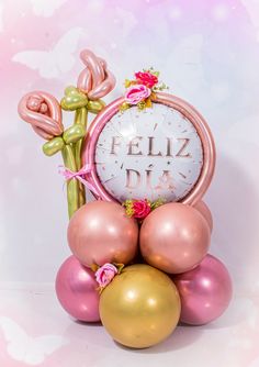 a clock surrounded by balloons and flowers