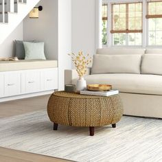 a living room filled with furniture and a staircase leading to the upper floor above it