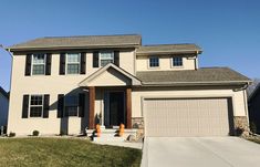 a two story house with white siding and black shutters