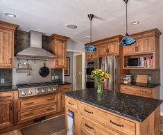 a kitchen with wooden cabinets and granite counter tops