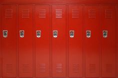 a row of red lockers sitting next to each other