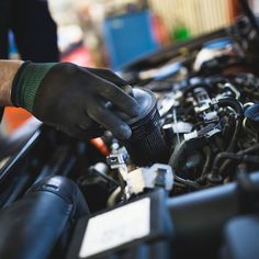 a man working on an engine in his car