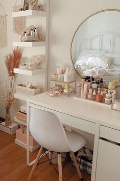 a white desk topped with a mirror next to a chair and shelf filled with cosmetics