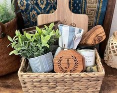 a basket filled with lots of items on top of a wooden table next to potted plants