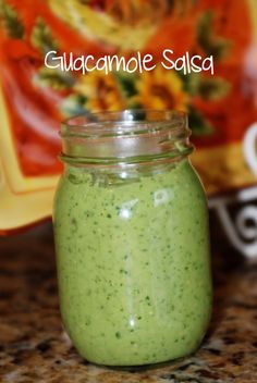 a jar filled with green liquid sitting on top of a counter