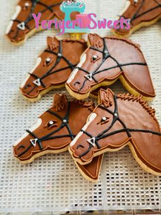 decorated cookies in the shape of horses on a table