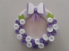 a purple and white wreath made out of buttons