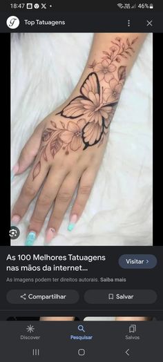 a woman's hand with a butterfly tattoo on it