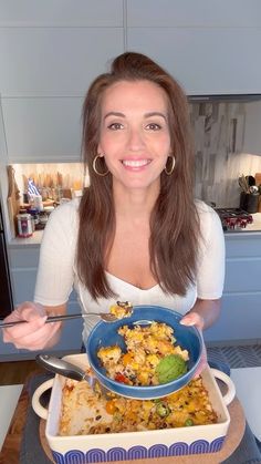 a woman sitting at a table with a plate of food in front of her,