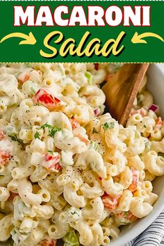 macaroni salad in a white bowl with a wooden spoon on the side and text overlay