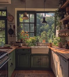 a kitchen filled with lots of green cupboards and counter top next to a window