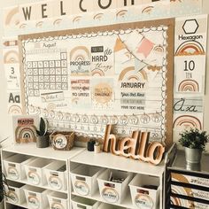 a bulletin board with the word hello written on it in front of some bins