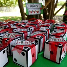 many boxes with red and white designs on them are sitting in front of a tree