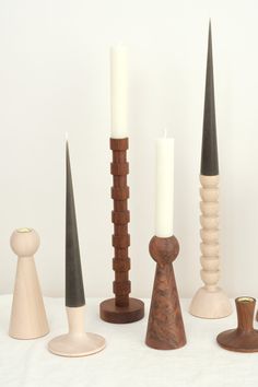 a group of different sized candles sitting next to each other