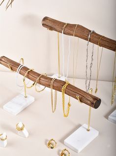 several different types of jewelry hanging from a wooden rack