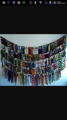 a wall hanging made out of many different colored bracelets on it's side