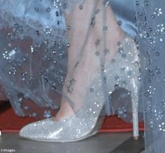 a woman's feet in high heels with silver sequins