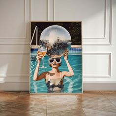 a woman holding up a crystal ball over her head in front of a swimming pool