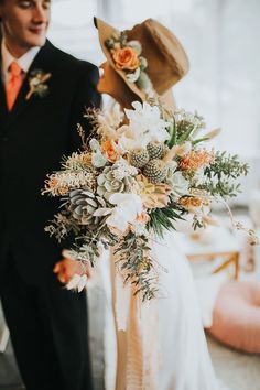 a bride and groom standing next to each other