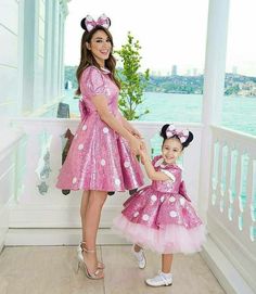 a mother and daughter dressed in minnie mouse costumes