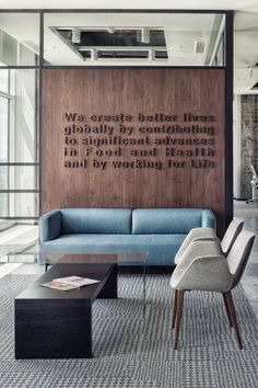 a living room filled with furniture and a quote on the wall