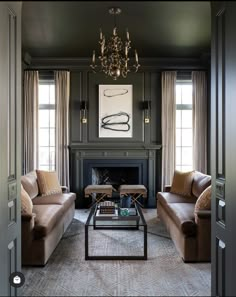 a living room with two couches and a coffee table in front of a fireplace