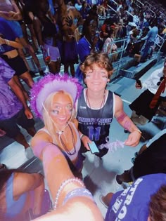 two young people dressed in costumes at a sporting event