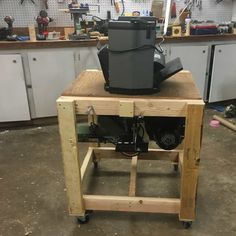 a workbench in a garage with tools and equipment on the table, including a cooler