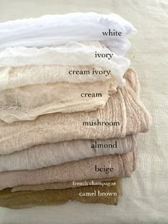 a stack of folded linens with labels on them showing the names of each item