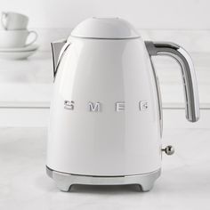 an electric kettle with the word smeg on it