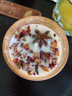 a bowl filled with yogurt and granola on top of a black table