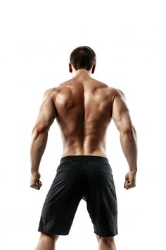 a man with no shirt is standing in front of a white background and has his back turned to the camera