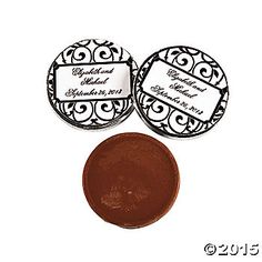 two round labels on top of each other next to a brown button with an ornate design