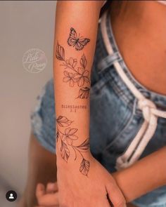 a woman with a butterfly tattoo on her arm