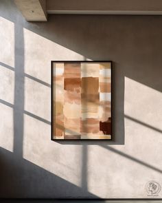 an abstract painting hangs on the wall next to a window