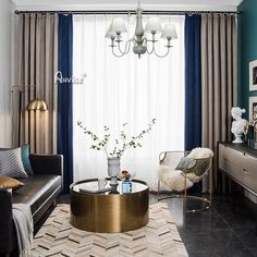 a living room filled with furniture and a chandelier hanging from the ceiling over a coffee table