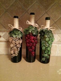 three bottles filled with different types of wine sitting on top of a counter next to each other