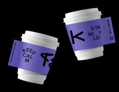 two coffee cups with the words keep calm printed on them, one is purple and the other is white